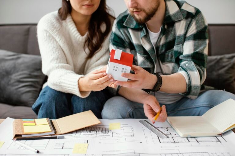 couple-holding-small-house-close-up